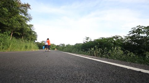 Children have fun to play on the road in countryside of Thailand