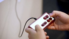 Retro classic gamepad and hands of player. Player pressing buttons and playing in video game. Close up view - Powered by Shutterstock - Get 15% off with code: PIKWIZARD15