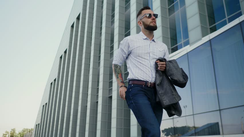 Confident well-dressed man with beard vaping an electronic cigarette Royalty-Free Stock Footage #30037678