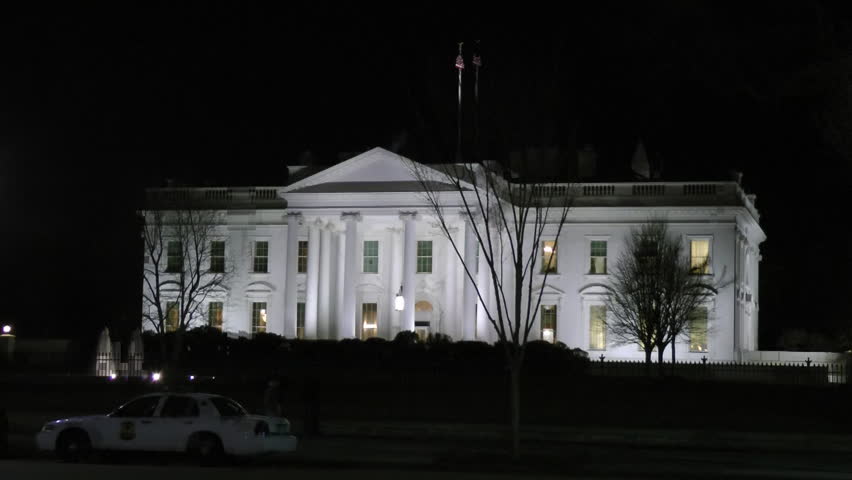 White House, parked police car, bike passes. Against the black night sky, the blinking red light beyond roof is Washington Monument, a nice counterpoint to fountain lower left.   Quick zoom in at end.
