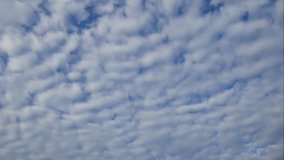 Time lapse of timelapse of bue sky with white cloud. Royalty high-quality stock video footage of time lapse bright blue sky white fluffy clouds on clear sunny day. Natural cloudscape sky background