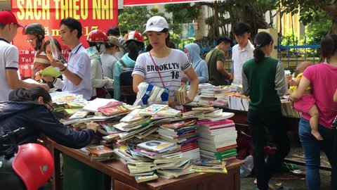 BUON MA THUOT, VIETNAM - JUNE 1, 2017: People sell and buy second hand and new textbooks at discounts in the street.