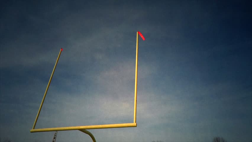 Football Goal Post - Time-lapse - A time-lapse of the football field goal post. The wind is blowing the flags as the clouds roll by.  Royalty-Free Stock Footage #3004252