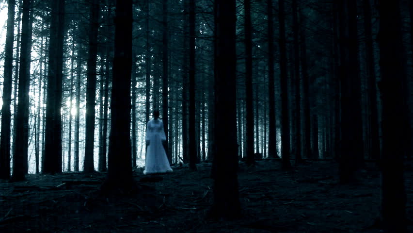 Mysterious woman in white dress in dark spooky forest Royalty-Free Stock Footage #3004645