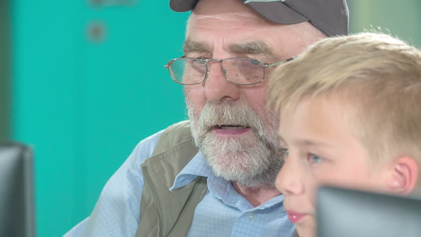 Two guys are trying to learn computer basics. They