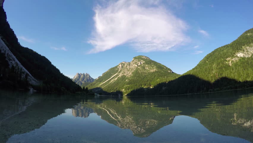 4K. Sunset at amazing alpen lake, time lapse with deep mooving shadows. Predil Lake (Lago Del Predil), alps mountains, Italy, Europe. 