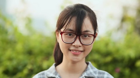 Portrait of a cute simple Vietnamese girl student. Face close-up.