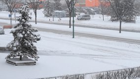Winter snowstorm. Car traffic on slippery road.