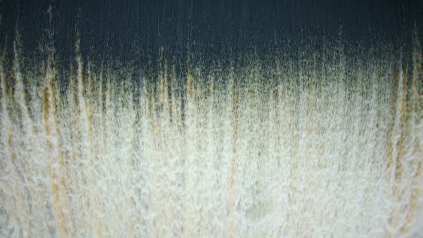 Powerful stream of water falls in slowmotion