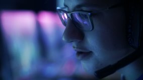 Professional Gamer Plays in MMORPG/ Strategy Video Game on His Computer. He's Participating in Online Cyber Games Tournament, Plays at Home, or in Internet Cafe. He Wears Glasses and Gaming Headset.