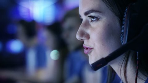 Beautiful Professional Gamer Girl and Her Team Participate in eSport Cyber Games Tournament. She Has Her Headphones and Talks into Microphone. Shot on RED EPIC-W 8K Helium Cinema Camera. Video Stok