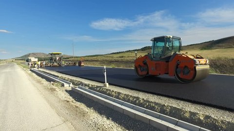 Skopje, Macedonia - 31 Jul, 2017: Road construction. Road roller doing repair and paving of streets, Building s New Road with Road Repair