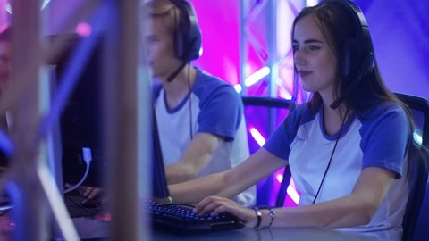 Team of Teenage Gamers Play in Multiplayer Video Game on a eSport Tournament, High-Fives Each other. Shot on RED EPIC-W 8K Helium Cinema Camera.