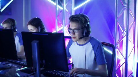 Team of Teenage Gamers Win Internet Cafe Online Video Gaming Tournament and Celebrate with High-Fives. Emotional Game Moment. Shot on RED EPIC-W 8K Helium Cinema Camera. 4K UHD.