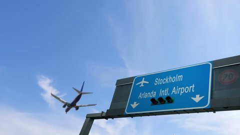 airplane flying over stockholm airport signboard
