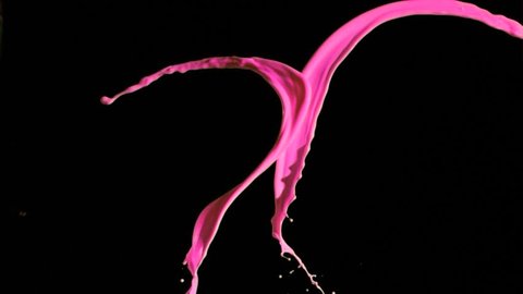 Pink paint lines in super slow motion mixing against a black background