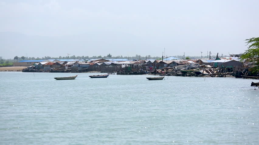 Wide angle view of low income houses built up along the shore