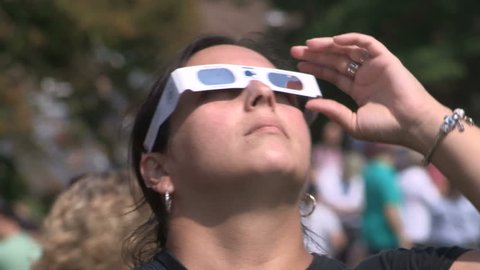 Waterloo, Ontario, Canada August 21 2017 Solar eclipse on college campus and students with telescopes and glasses