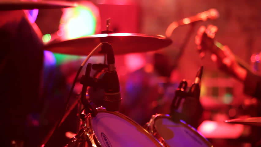 Two close ups of a man preforming on a drum set during a concert. | Shutterstock HD Video #3010066