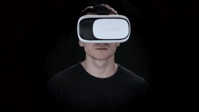 Young man on black background with glasses virtual reality