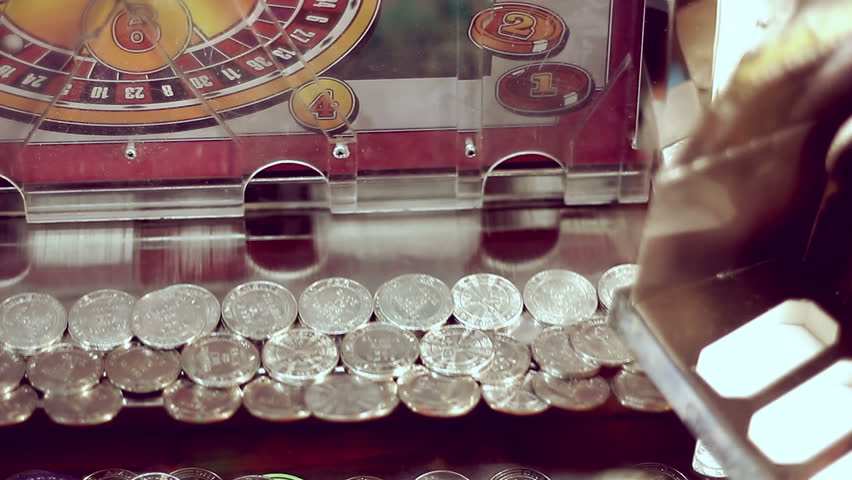 Coins moving inside gambling machine in amusement park