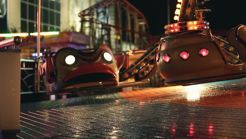 Carousels in amusement park at night