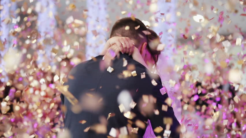 Young beautiful bride and groom dancing first dance at the wedding party shrouded by confetti. Wedding bouquet. Feel happy. Royalty-Free Stock Footage #30111541