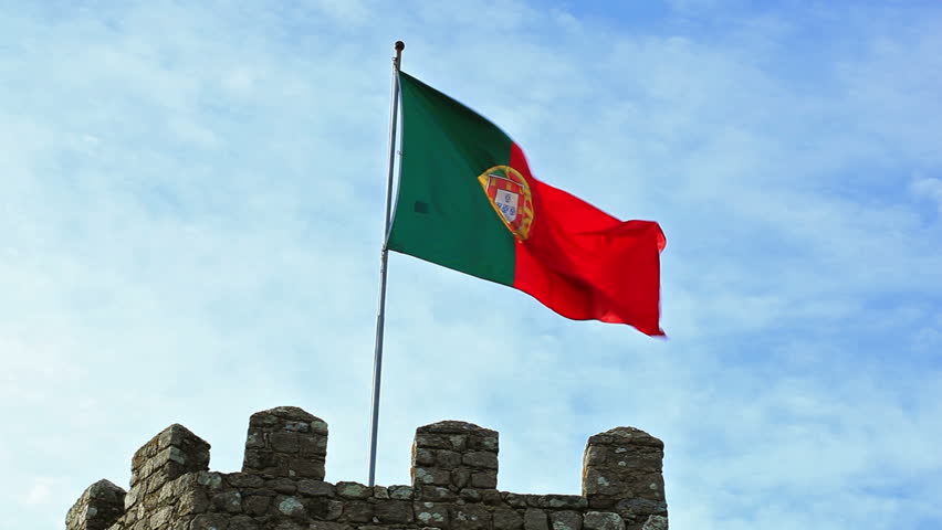 Portugal flag in fortress tower against blue sky
