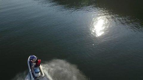 Aerial view on man enjoying water jet ski on lake