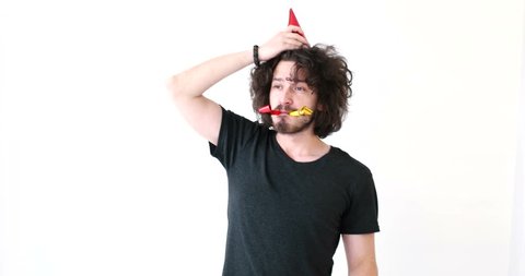 Man having fun while playing with party blowers