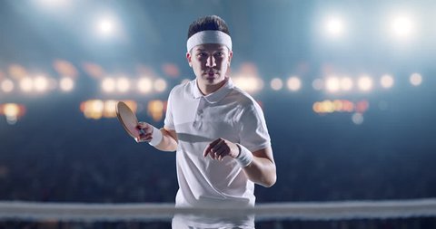 Ping pong player in action on a professional sports arena. He is wearing unbranded clothes.  Arkivvideo