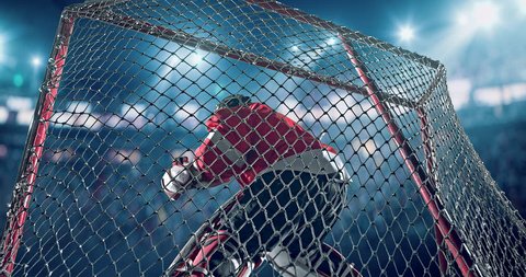 Ice Hockey goalie saves a goal on a hockey arena with intensional lens flares. He is wearing unbranded sports clothes.