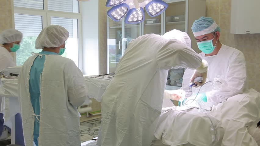 The surgical group of the hospital performs an operation using sterile surgical instruments Royalty-Free Stock Footage #30132022