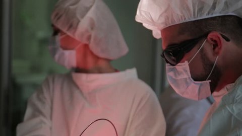 Close-up. The surgeon carries out a surgical procedure to remove the cancer tumor. Photodynamic therapy