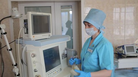 A female surgeon assembles an electronic innovative medical device for surgical operation. New medical technologies
