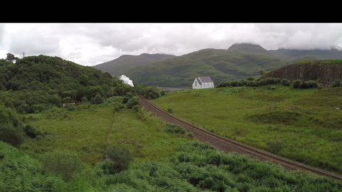 Aerial Footage of TheJacobite Steam Train travelling from Fort William en-route to Mallaig, Scottish Highlands, Scotland, United Kingdom