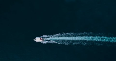 Slow Motion Aerial Shot Fly Over Small Yacht Speed Boat Splitting Deep Blue Ocean Tropical Paradise Panorama Summer Vacation Destination Summer Getaway Concept 4k