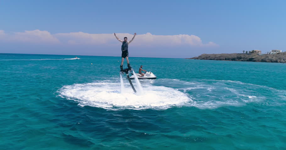 Aerial Quadcopter View Over Young Man Riding A Jet Ski Flyboard In Ocean Clear Blue Water Extreme Sports Vacation Trip Adventure Exotic Summer Getaway Concept Hot Summer Day