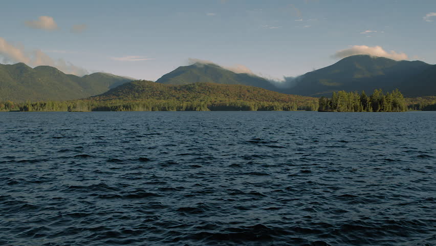 Misty mountain sunrise over a lake.