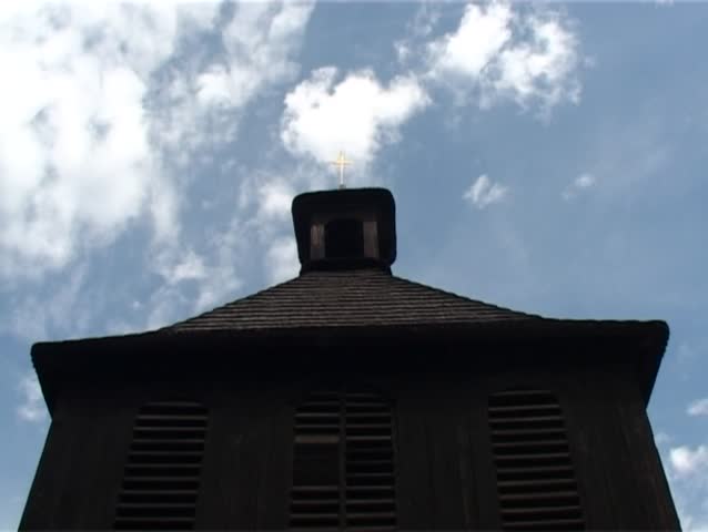 Bell tower with flowing clouds above. Fast motion.