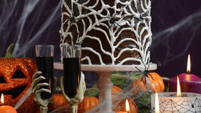 Spooky Halloween Party Table with chocolate spider cake, close up pan up handheld.  - Powered by Shutterstock - Get 15% off with code: PIKWIZARD15