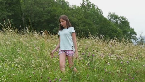 teenage girl walking in the countryside, slow motion