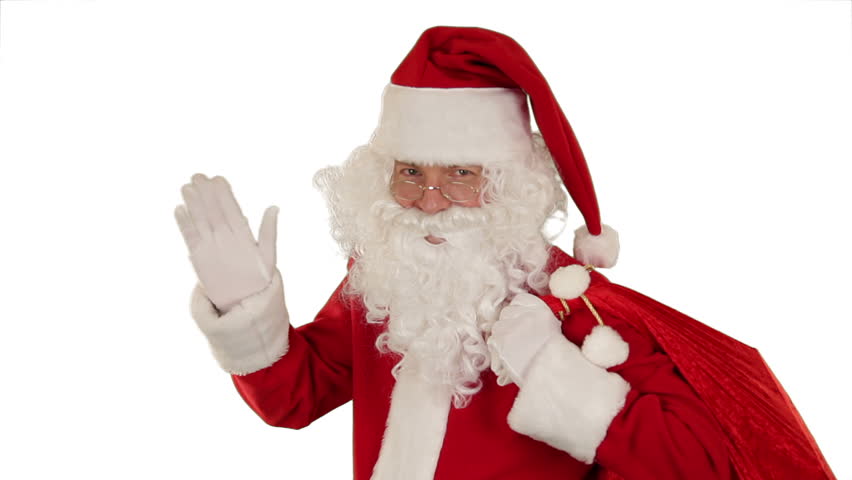 Santa Claus carrying his bag, looks at the camera sends a blow kiss and wave,