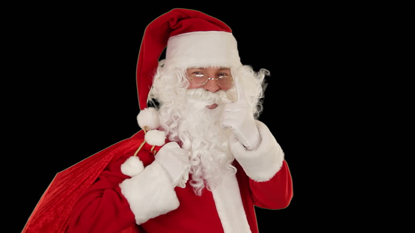 Santa Claus carrying his bag, looks at the camera sends a kiss and wave, black
