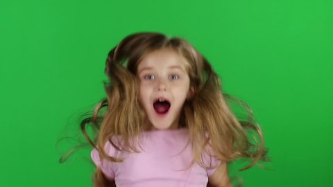 Baby jumps, emotions of happiness and fun. Green screen. Slow motion