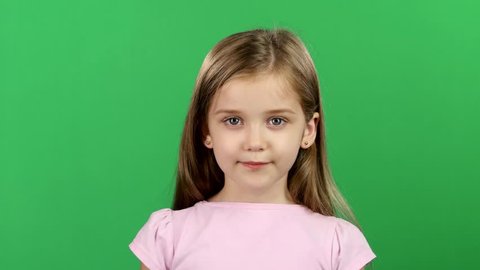 Child is holding a magnifying glass. Green screen