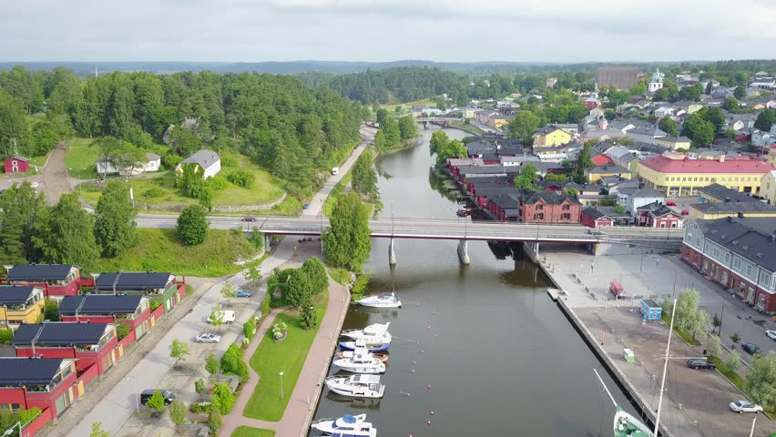 4K aerial video footage view of medieval Porvoo old town on river Porvoonjoki, cathedral, river embankment, boats, old warehouses and area 50 km east of Helsinki, capital of Finland in northern Europe