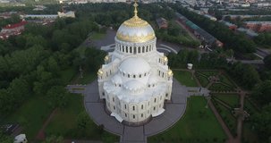 4K aerial video footage view of beautiful Nikolskiy Navy cathedral, anchor square, area around it in the heart of Kronstadt town near St Petersburg 700 km from Moscow, Russia on clear summer morning