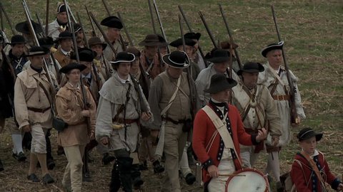 VIRGINIA - OCTOBER 2016 - Reenactment, large-scale, epic American Revolutionary War anniversary recreation -- U.S. Continental Army Soldiers in formation marching as on parade with Muskets, flags.