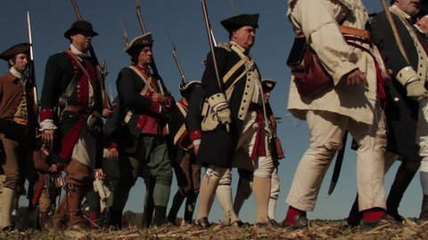 VIRGINIA - OCTOBER 2016 - Reenactment, large-scale, epic American Revolutionary War anniversary recreation -- U.S. Continental Army Soldiers in formation marching as on parade with Muskets, flags.